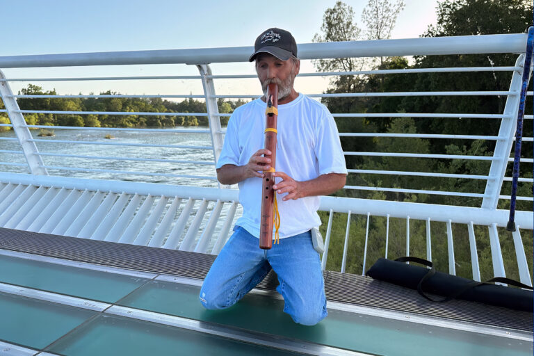 Indigenous flute player on Redding's Sundial Bridge